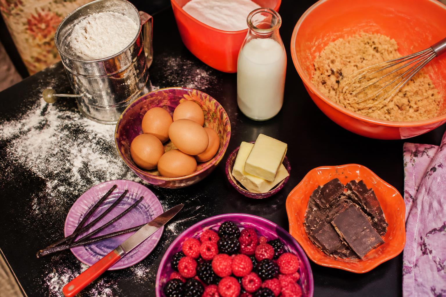 Real baking ingredients and cookie dough on a dark worktable